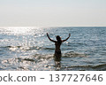 Young woman enjoying the sunshine while swimming on summer vacation on seaside 137727646