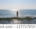 Young woman silhouette going into the sea to swim in sunny day 137727650