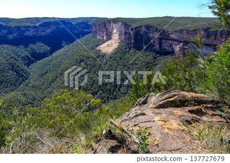 Scenic view across the Blue Mountains landscape from Evans Lookout in Blackheath, New South Wales, Australia, overlooking the Grose Valley with cliffs, forest and expansive mountain scenery. Scenic view across the Blue Mountains landscape from Evans Lookout in Blackheath, New South Wales, Australia, overlooking the Grose Valley with cliffs, forest and expansive mountain scenery. 137727679