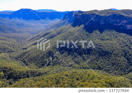 Scenic view across the Blue Mountains landscape from Evans Lookout in Blackheath, New South Wales, Australia, overlooking the Grose Valley with cliffs, forest and expansive mountain scenery. Scenic view across the Blue Mountains landscape from Evans Lookout in Blackheath, New South Wales, Australia, overlooking the Grose Valley with cliffs, forest and expansive mountain scenery. 137727684