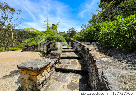 Scenic view across Everglades Gardens in the Blue Mountains of New South Wales, Australia, showing landscaped gardens, pathways and surrounding mountain scenery. Scenic view across Everglades Gardens in the Blue Mountains of New South Wales, Australia, showing landscaped gardens, pathways and surrounding mountain scenery. 137727700