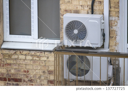 air conditioning on facade of building, air cooling in hot weather. air conditioning on facade of building, air cooling in hot weather. 137727725