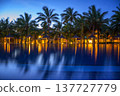 Resort swimming pool in Mauritius with palm trees and lights after sunset. 137727779