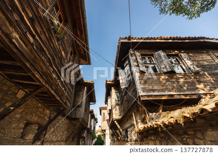 Traditional wooden houses above stone walls on narrow street in old town Nessebar Bulgaria Traditional wooden houses above stone walls on narrow street in old town Nessebar Bulgaria 137727878
