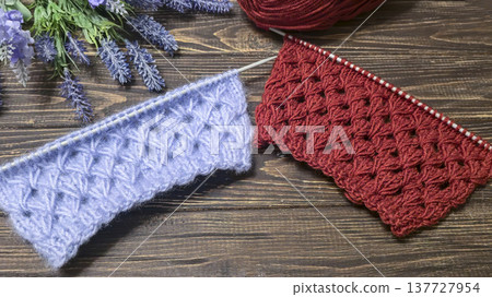 Knitting patterns with a raised pattern and yarn on a dark background Terracotta Knitting patterns with a raised pattern and yarn on a dark background Terracotta 137727954