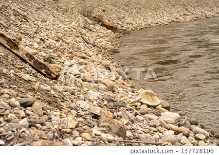 View of the stone bank of a mountain river in early spring View of the stone bank of a mountain river in early spring 137728106