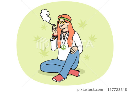 Hippie woman smokes cannabis sitting on summer lawn, enjoying participating in rastafarian community 137728848