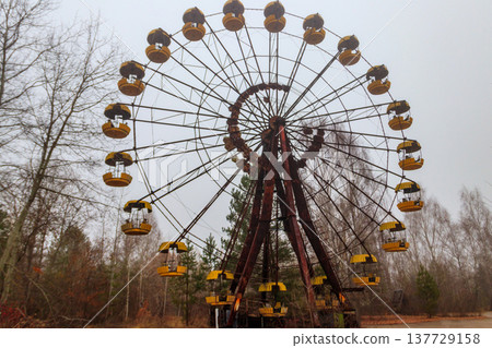 Abandoned Ferris Wheel in the amusement park of ghost town Pripyat in Chernobyl Exclusion Zone, Ukraine Abandoned Ferris Wheel in the amusement park of ghost town Pripyat in Chernobyl Exclusion Zone, Ukraine 137729158