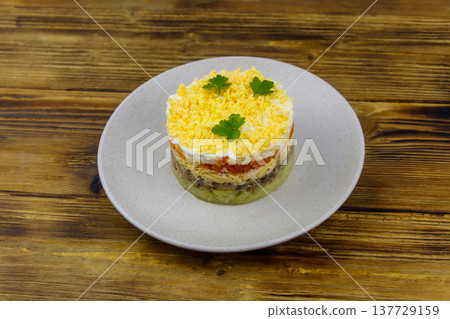 Traditional russian salad Mimosa on wooden table Traditional russian salad Mimosa on wooden table 137729159