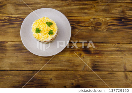 Traditional russian salad Mimosa on wooden table. Top view Traditional russian salad Mimosa on wooden table. Top view 137729160