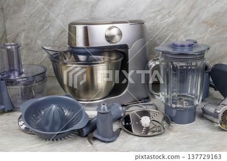 Modern kitchen machine with different attachments and accessories 137729163