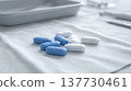 Elegant macro of blue and white oblong tablets on sterile white drape 137730461