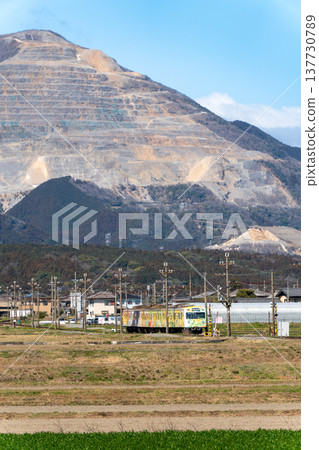 Sangi Railway Sangi Line train set 801, wrapped with a design, running with Mount Fujiwara in the background. Sangi Railway Sangi Line train set 801, wrapped with a design, running with Mount Fujiwara in the background. 137730789
