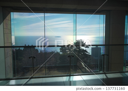 A view of the sparkling sea outside the window from the lobby of the MOA Museum of Art in Atami. A view of the sparkling sea outside the window from the lobby of the MOA Museum of Art in Atami. 137731160