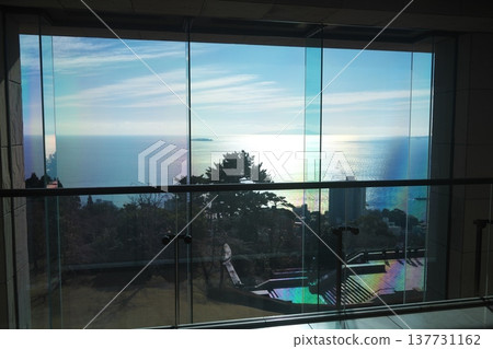 A view of the sparkling sea outside the window from the lobby of the MOA Museum of Art in Atami. A view of the sparkling sea outside the window from the lobby of the MOA Museum of Art in Atami. 137731162