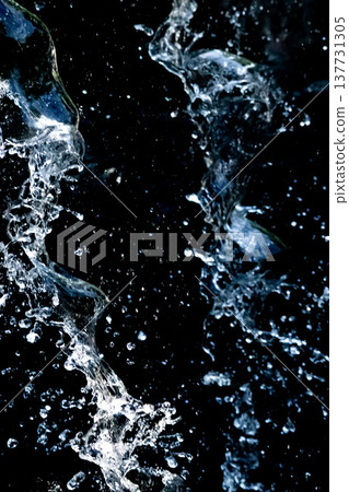 Vertical composition of water splashes and black background Vertical composition of water splashes and black background 137731305