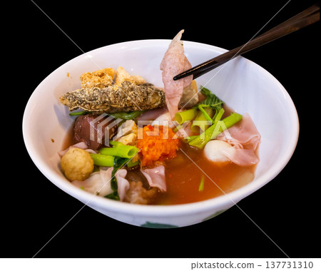 Top view of Yentafo Pink seafood flat noodles with fish meatballs, focus selective Top view of Yentafo Pink seafood flat noodles with fish meatballs, focus selective 137731310