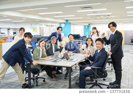 一大群商務人士,男女都有,聚集在寬敞的辦公室。 一大群商務人士,男女都有,聚集在寬敞的辦公室。 137731838