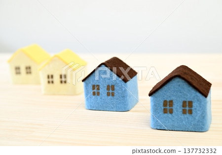 A small house placed on a wooden table A small house placed on a wooden table 137732332