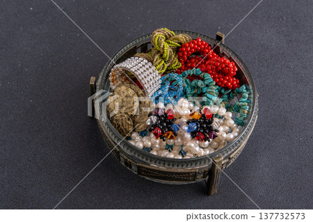 Jewelry box with vintage beaded earrings on black background 137732573