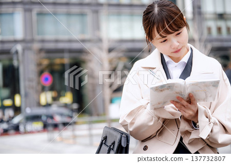 Young business woman looking at her notebook 137732807