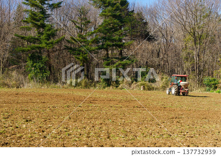 Tractor sowing grass seeds 137732939