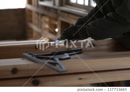 The craftsmanship of a carpenter carving wood using traditional techniques: Scenes of handiwork using chisels at a construction site. The craftsmanship of a carpenter carving wood using traditional techniques: Scenes of handiwork using chisels at a construction site. 137733665