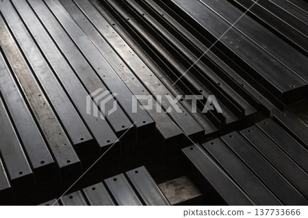Black steel square pipes and steel materials lined up in the factory: Industrial materials that support Japan's manufacturing and infrastructure. 137733666