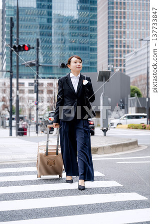 A businessman carrying a carry-on bag 137733847