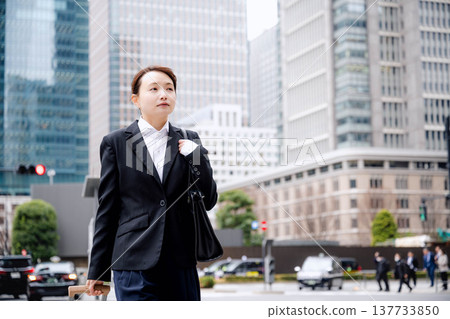 A businessman carrying a carry-on bag A businessman carrying a carry-on bag 137733850