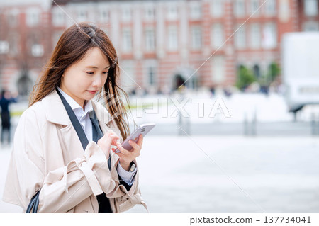 操作智能手機的女商人戶外 操作智能手機的女商人戶外 137734041