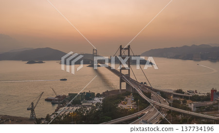 Iconic Suspension Bridge Illuminated At Sunset Over Tranquil Waters Feb 21 2026 137734196