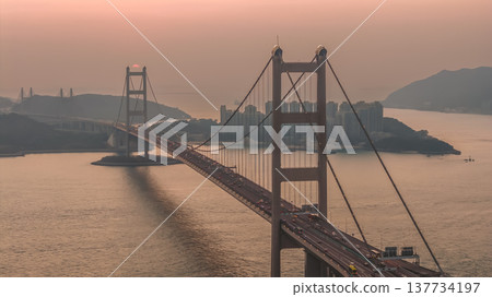 Iconic Suspension Bridge Illuminated At Sunset Over Tranquil Waters Feb 21 2026 137734197