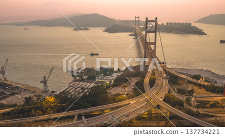 Iconic Suspension Bridge Illuminated At Sunset Over Tranquil Waters Feb 21 2026 Iconic Suspension Bridge Illuminated At Sunset Over Tranquil Waters Feb 21 2026 137734221