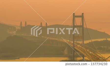 Iconic Suspension Bridge Illuminated At Sunset Over Tranquil Waters Feb 21 2026 Iconic Suspension Bridge Illuminated At Sunset Over Tranquil Waters Feb 21 2026 137734230