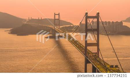 Iconic Suspension Bridge Illuminated At Sunset Over Tranquil Waters Feb 21 2026 Iconic Suspension Bridge Illuminated At Sunset Over Tranquil Waters Feb 21 2026 137734231