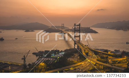 Iconic Suspension Bridge Illuminated At Sunset Over Tranquil Waters Feb 21 2026 137734233