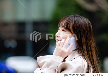 A businesswoman making a phone call while out and about. A businesswoman making a phone call while out and about. 137734370