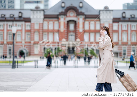 A businesswoman making a phone call while out and about. A businesswoman making a phone call while out and about. 137734381