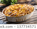Golden-brown gratin potatoes, neatly arranged in a white ceramic bowl. However, in Slovakia, this dish is known primarily at home as French potatoes. 137734571