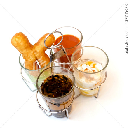 Top view of Deep fried dough sticks with tea or coffee, focus selective Top view of Deep fried dough sticks with tea or coffee, focus selective 137735028