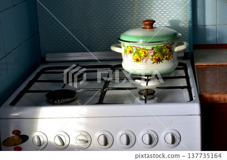 Gas stove and saucepan. Gas stove and saucepan. 137735164