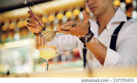 Professional bartender pouring straining cocktail preparing drink Professional bartender pouring straining cocktail preparing drink 137735453