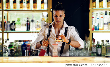 Professional bartender mixing a cocktail at a bar Professional bartender mixing a cocktail at a bar 137735466