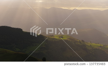 Sunlight rays illuminating green mountains in Cantabria Spain 137735483