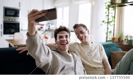 Gay couple taking selfie and enjoying time together at home 137735500
