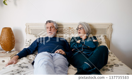 Senior couple experiencing disagreement in bedroom Senior couple experiencing disagreement in bedroom 137735583