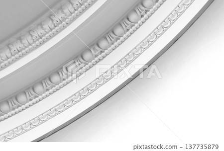 Intricate close-up of a white beaded plaster ceiling molding 137735879