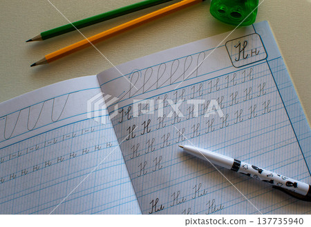 Back to school, learning to write letters correctly, notebook and pencils 137735940