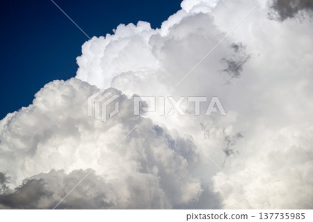 Large white cumulus thunderclouds against a blue sky before rain Large white cumulus thunderclouds against a blue sky before rain 137735985